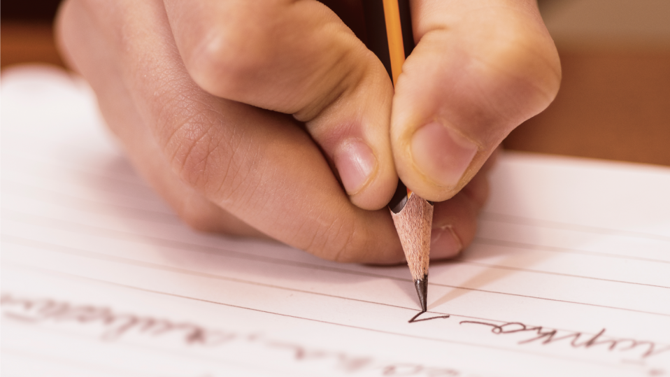 Primary pupil writing using writing templates to structure their ideas