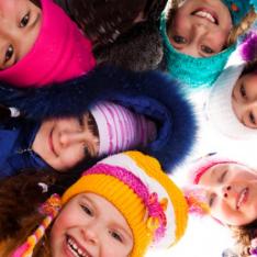 Primary children wearing winter clothes taking part in winter activity ideas for primary