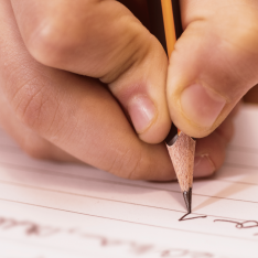 Primary pupil writing using writing templates to structure their ideas