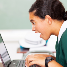 Student on a laptop working on computing challenges for secondary