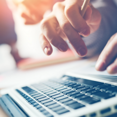 Student on laptop revising for their computing exams and assessments with computer science resources
