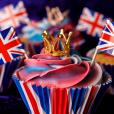 Cupcakes sat on a table decorated with crowns and union jacks ready for the Kings coronation celebration, primary teaching resources for King Charles III coronation