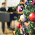 Christmas Tree With Teacher Playing Festive Music For Christmas Play for EYFS and Primary
