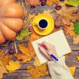 Autumn leaves on a table and a person writing autumn poetry to inspire secondary English students