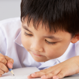 Young Child Writing To Demonstrate Comprehension Tasks Within Primary English Lessons