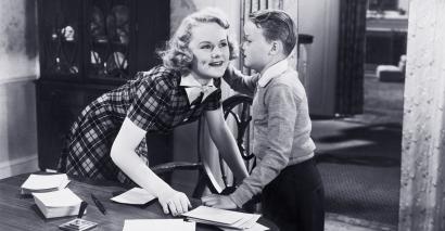 Old still of child saying something in teacher's ear