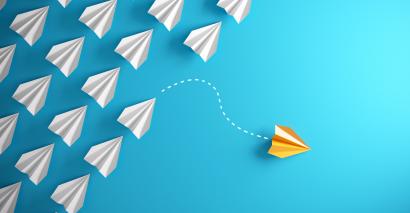 One paper aeroplane takes a different path from the rest