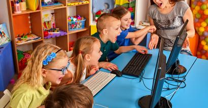 Children playing computer games in classroom