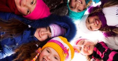 Primary children wearing winter clothes taking part in winter activity ideas for primary