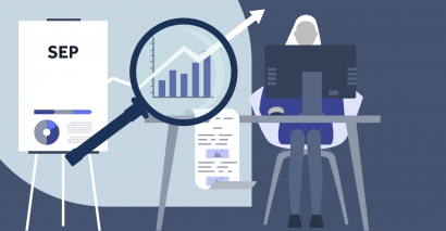 Woman sitting at computer next to a graph representing trends with a magnifying glass