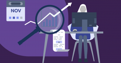 Woman sitting at computer next to a graph representing trends with a magnifying glass