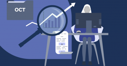 Woman sitting at computer next to a graph representing trends with a magnifying glass