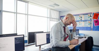 teacher with head in hands