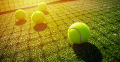 Tennis balls and net showing Wimbledon and tennis-themed resources for primary and secondary