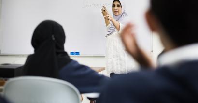 Dubai teacher in front of class teaching.