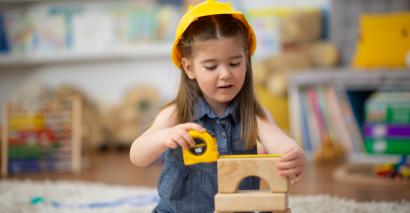 Child playing with construction area resources for EYFS and Primary