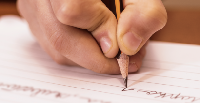 Primary pupil writing using writing templates to structure their ideas