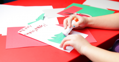 Primary pupil crafting a Christmas card using Tes Resources