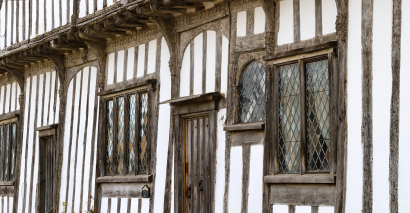 A Tudor house with wooden beams and white walls; studying Tudor housing and history in primary school