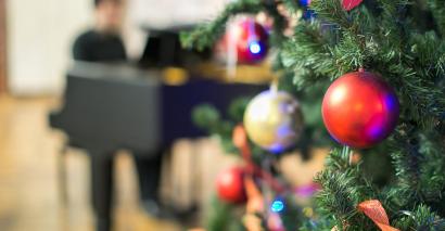 Christmas Tree With Teacher Playing Festive Music For Christmas Play for EYFS and Primary