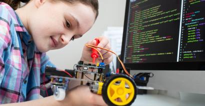 Student engaging in computer programming activities at secondary and primary