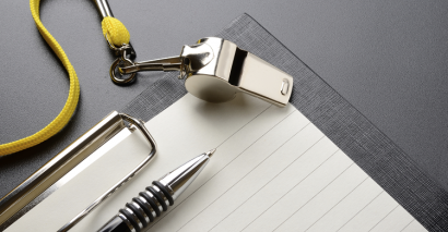 PE teacher whistle clipboard and pen for preparing to assess secondary PE students