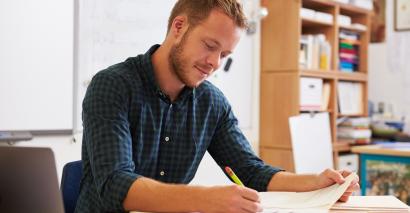 Teacher writing reports using secondary report-writing resources for ks3, ks4 and ks5