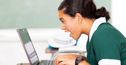 Student on a laptop working on computing challenges for secondary