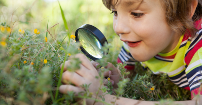 Child Taking Part In Outdoor Learning Activity with Resource for Primary Pupils