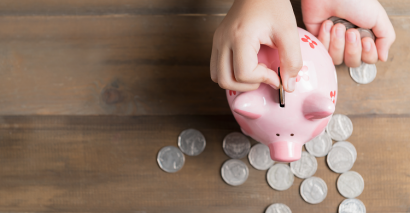 Child Saving Using A Piggy Bank Representing Primary Maths Lessons About Money, Coins, Notes, Pounds & Pence
