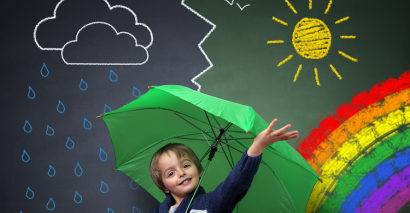 Primary Pupil Holding An Umbrella Standing In Front Of Different Seasons and Types Of Weather