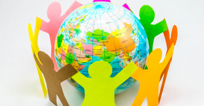 A globe surrounded by a circle of paper people symbolising World Religion Day