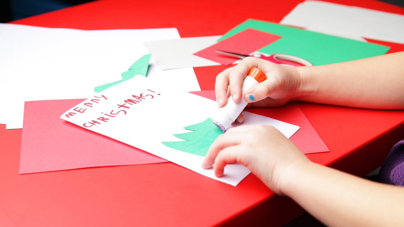 Primary pupil crafting a Christmas card using Tes Resources