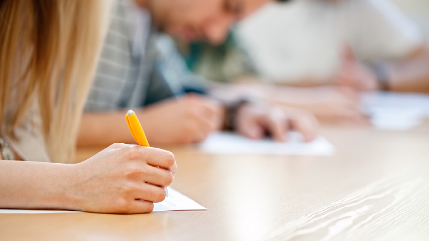 Secondary student practising their essay writing skills with a range of supportive resources including essay writing guides, sentence starters and supportive worksheets