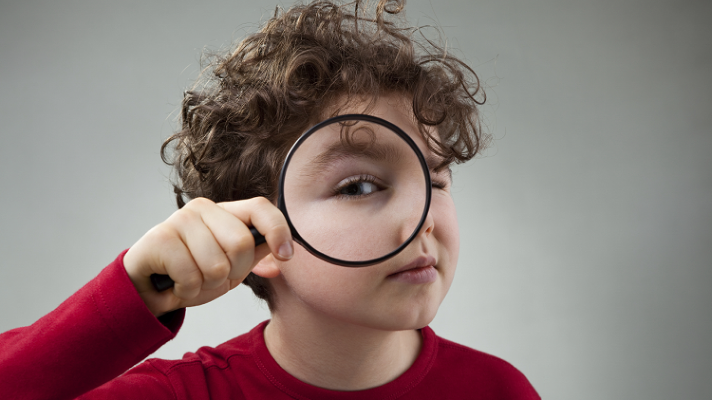 Child Holding A Magnifying Glass Solving A Mystery/looking At Something Closer