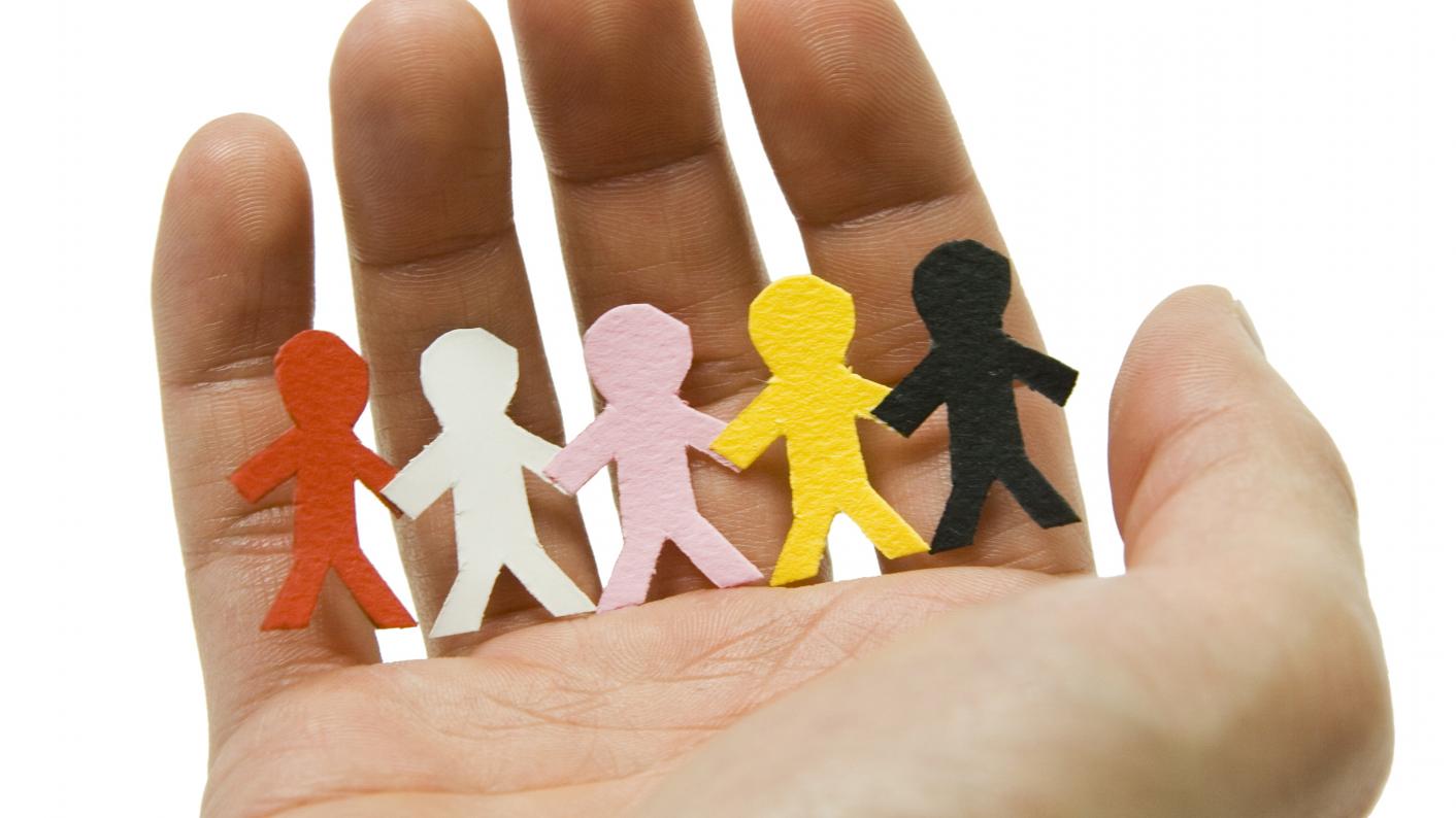 Paper people on a person's hand to signify People Who Help Us Resources