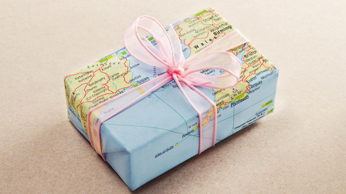World map Christmas wrapping paper on a present for Christmas around the world lesson ideas and resources