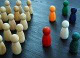 Colourful pawns confront a mass of unpainted pawns