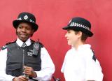 Black and white police officers talk to one another