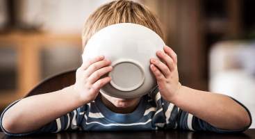 Pupil with face covered by bowl