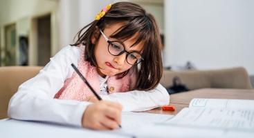 Child concentrating while writing