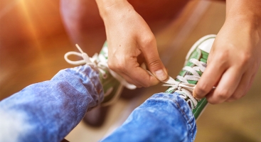 Parent tying shoe laces