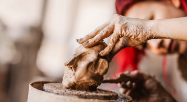 Hand sculpturing a clay figure
