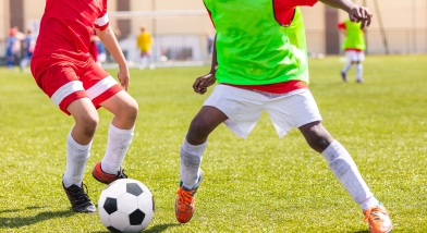 Two children playing game of football