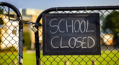 School closed sign on fence