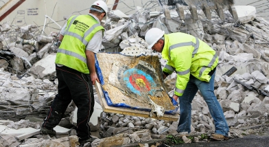 Two workmen chucking away target
