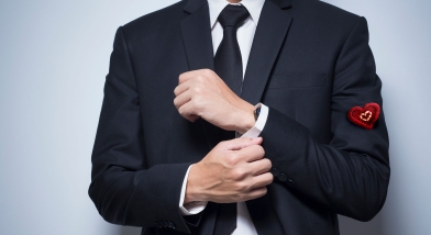 Man in suit with heart on sleeve