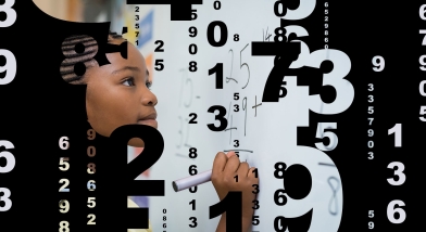 Girl working out sum on whiteboard