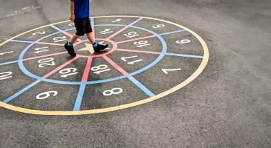 Pupil walking around numbers in playground
