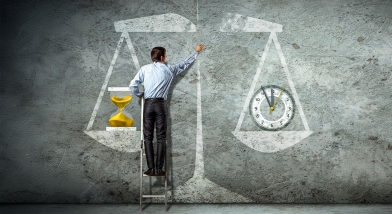 Man with drawing of scales weighing time